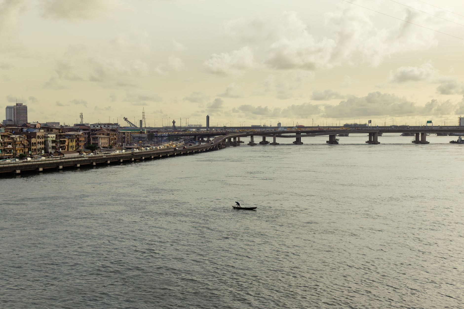 A monumental road bridge spanning across tranquil coastal waters connecting Lagos Island to the mainland
