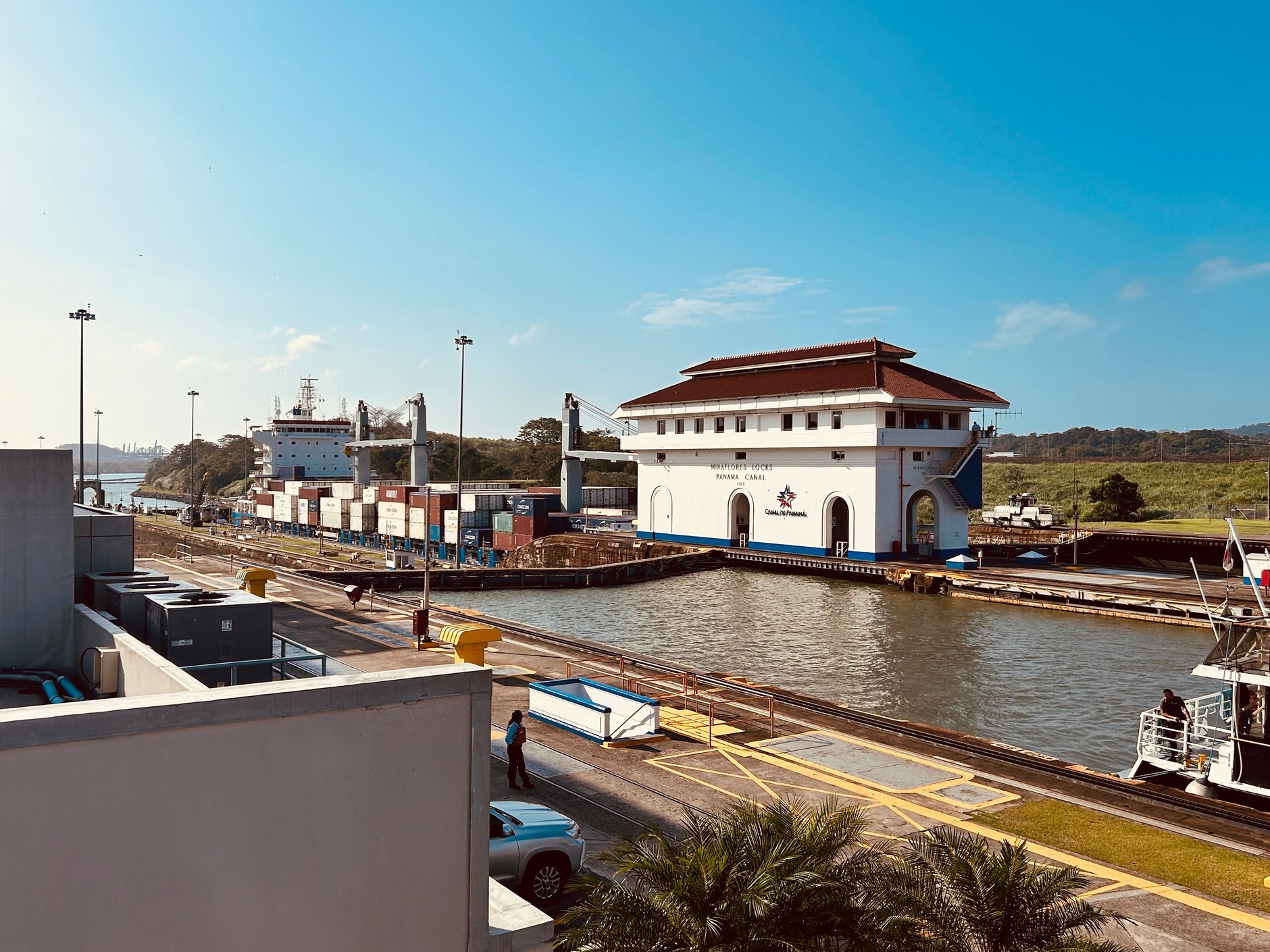 Large cargo container vessel navigating through the concrete chambers of the Miraflores Locks on the Panama Canal