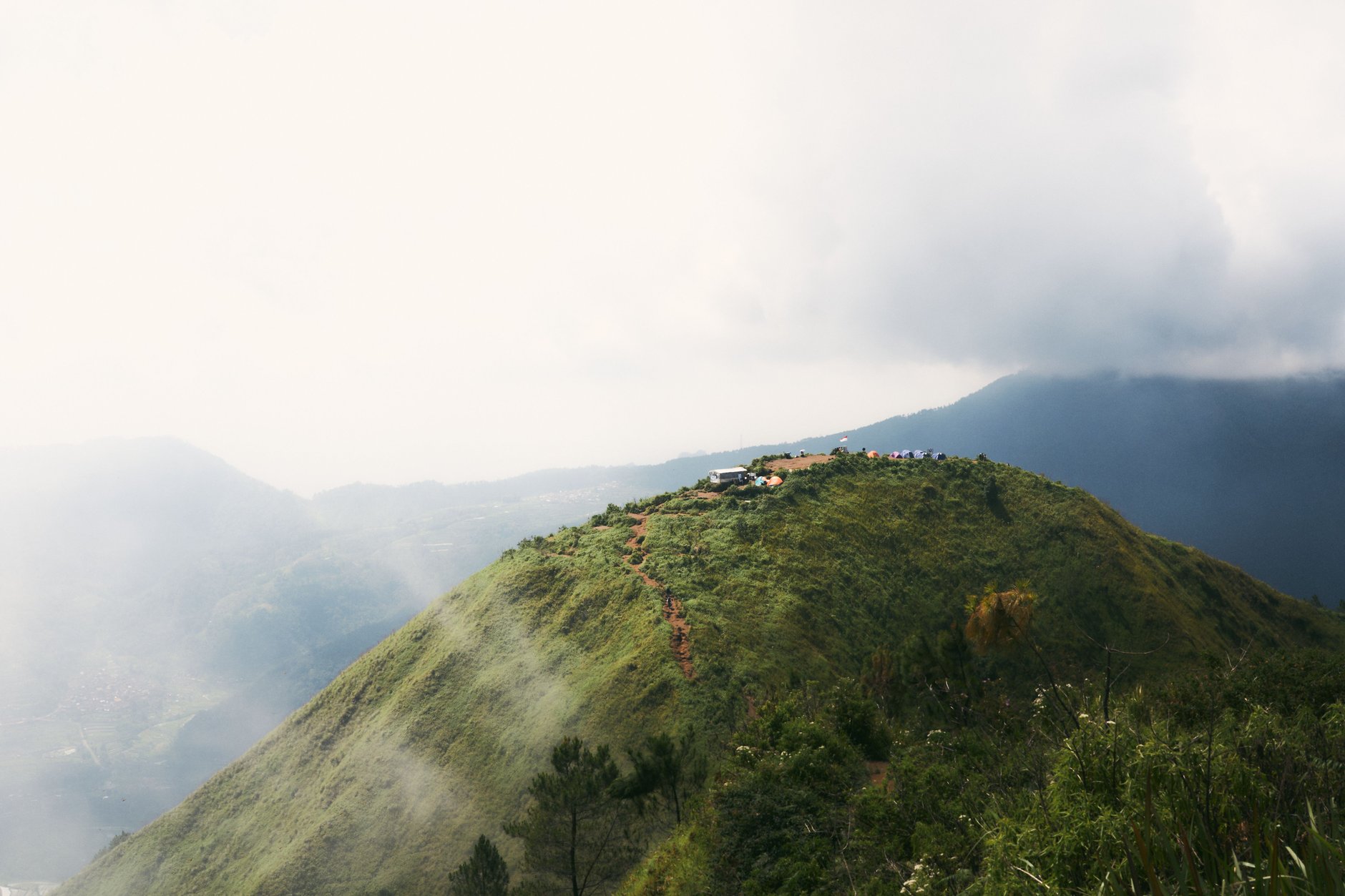 Hiking trail leading through lush high-altitude tropical forest towards the rugged peak of Volcan Baru in Panama
