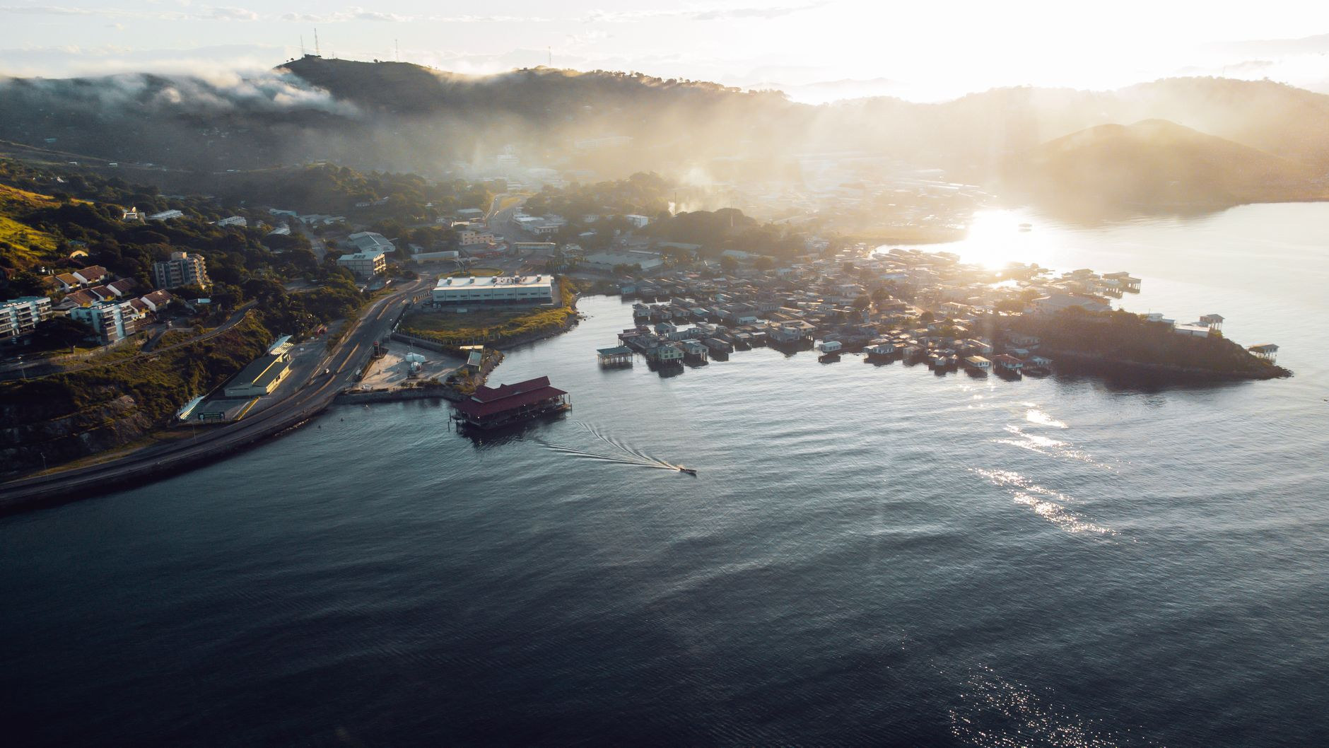 Aerial panorama over the natural deepwater harbor and rugged hills of Port Moresby at sunrise in Papua New Guinea