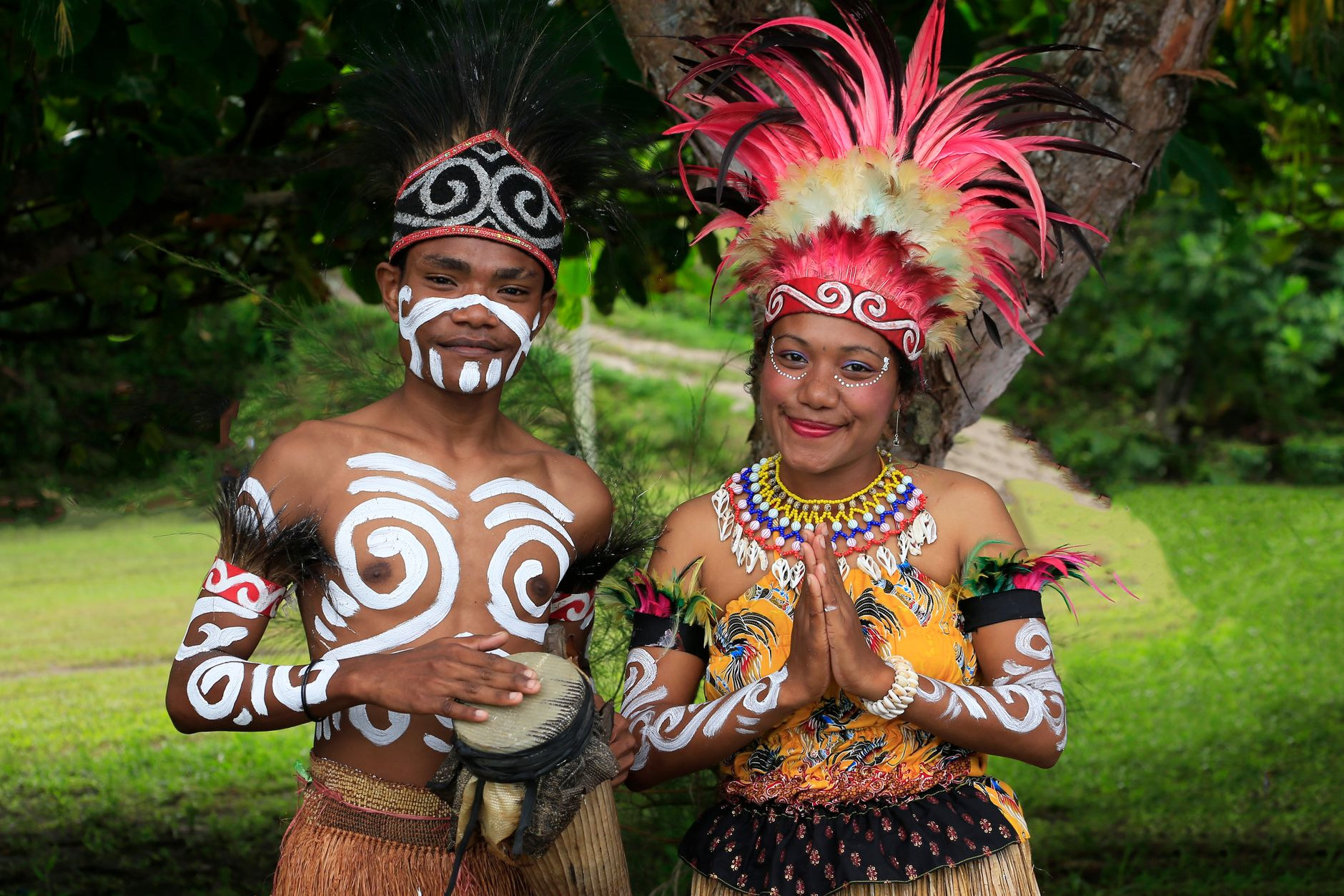 Traditional clay body ornamentation, hornbill beak adornments, and shell necklaces worn during a cultural ceremony in Papua New Guinea