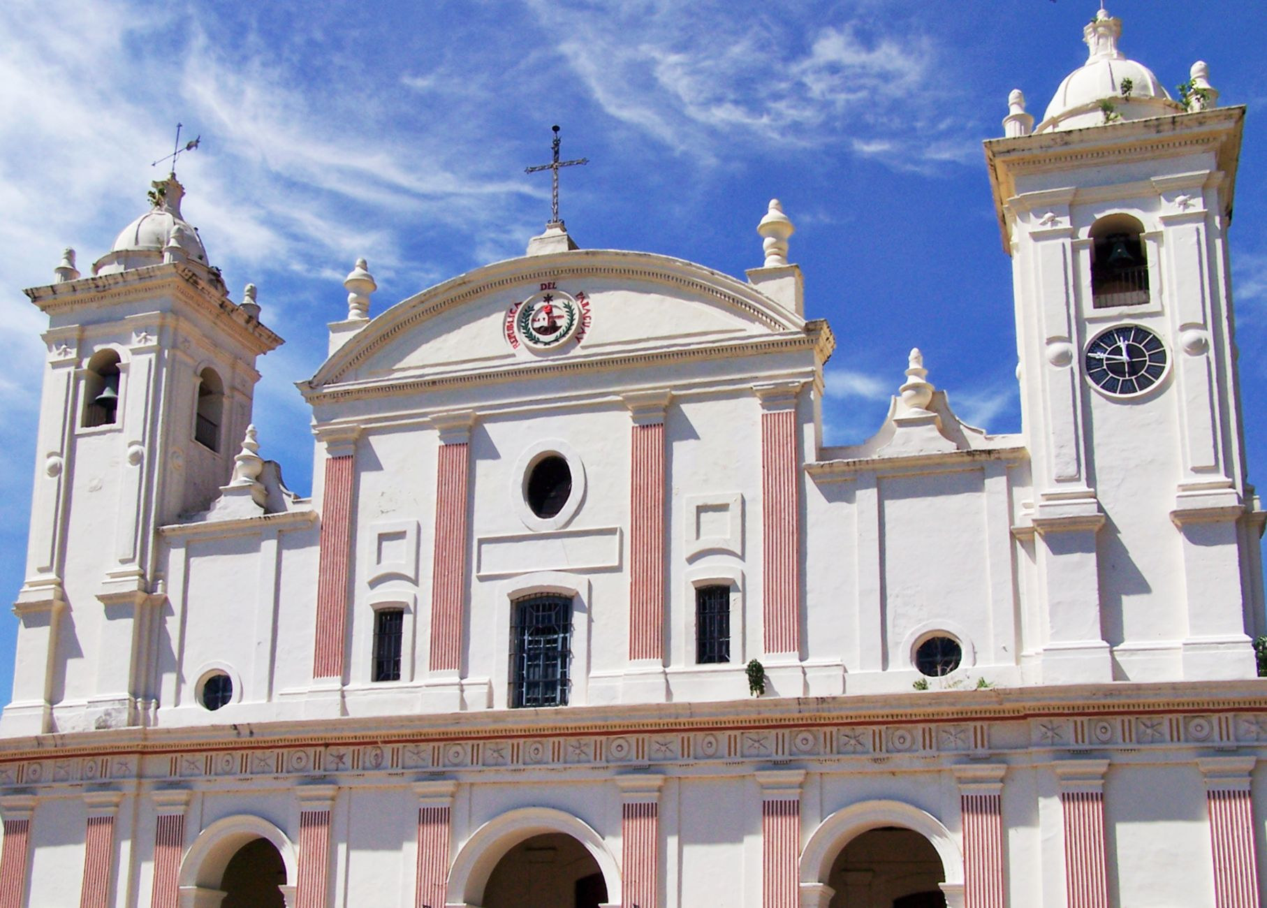 Classic neoclassical facade and twin belfries of the Metropolitan Cathedral of Our Lady of the Assumption under a clear blue sky