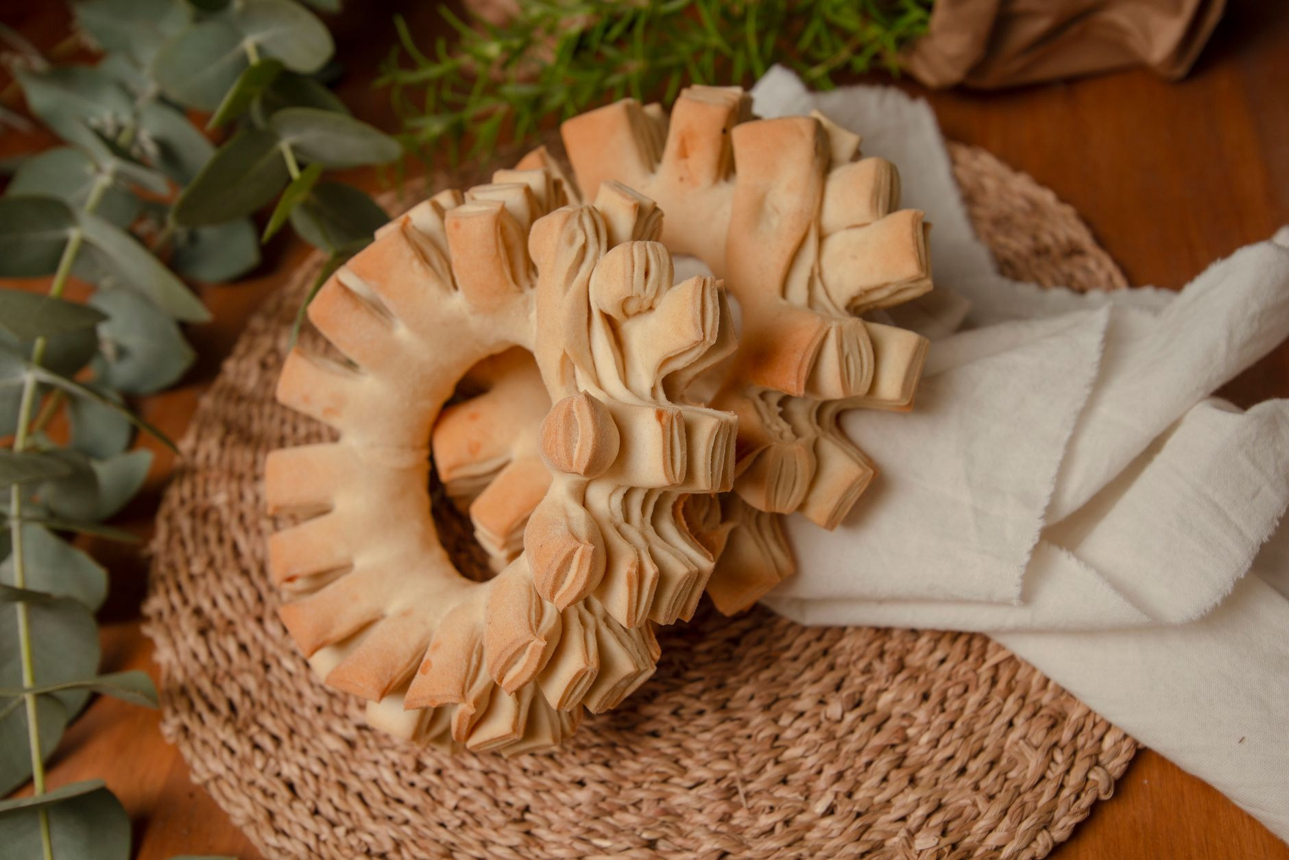Golden-brown baked rings of traditional Paraguayan chipa bread made with cassava starch and local cheese on a rustic cloth