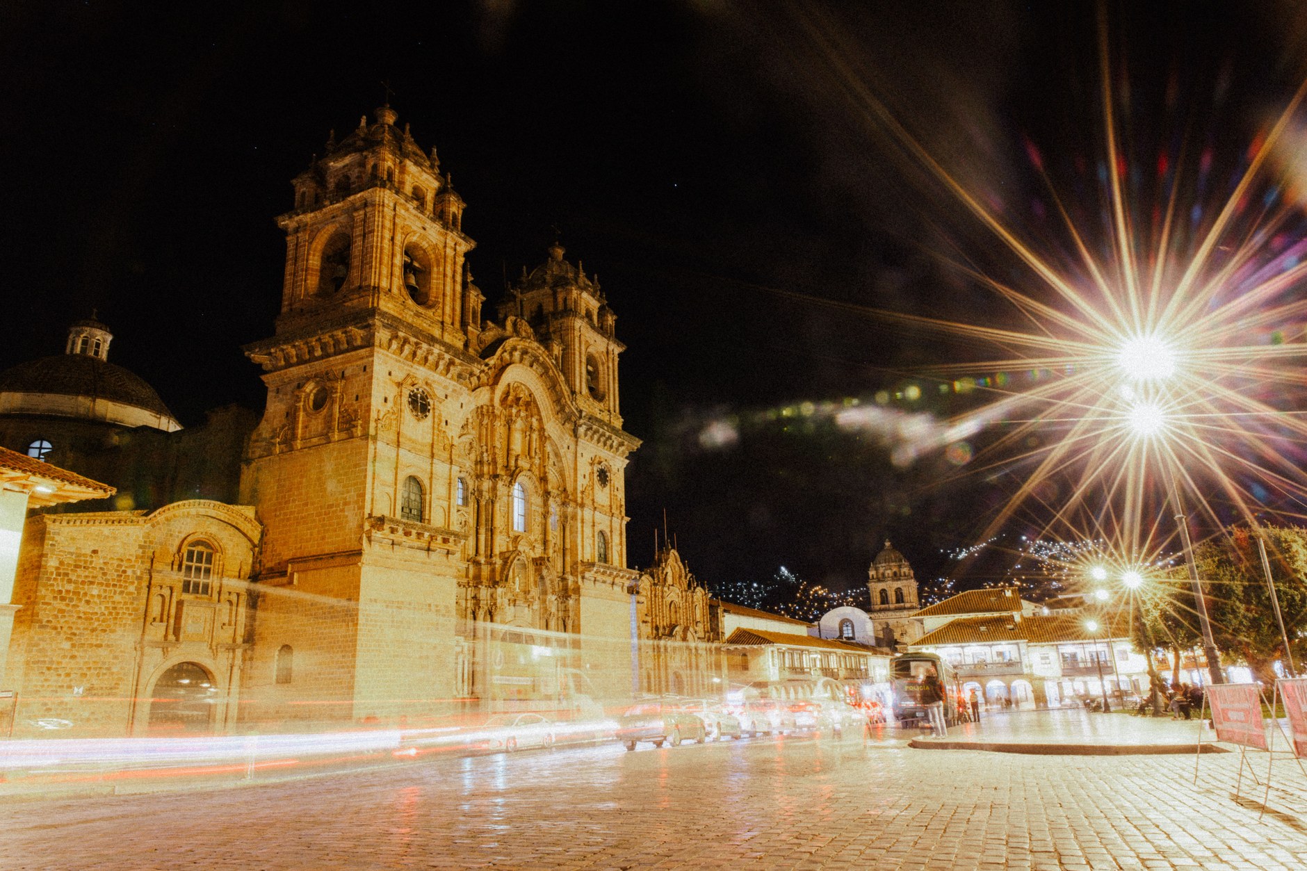 Colonial stone facade and bell towers of Cusco Cathedral on the Plaza de Armas at dusk