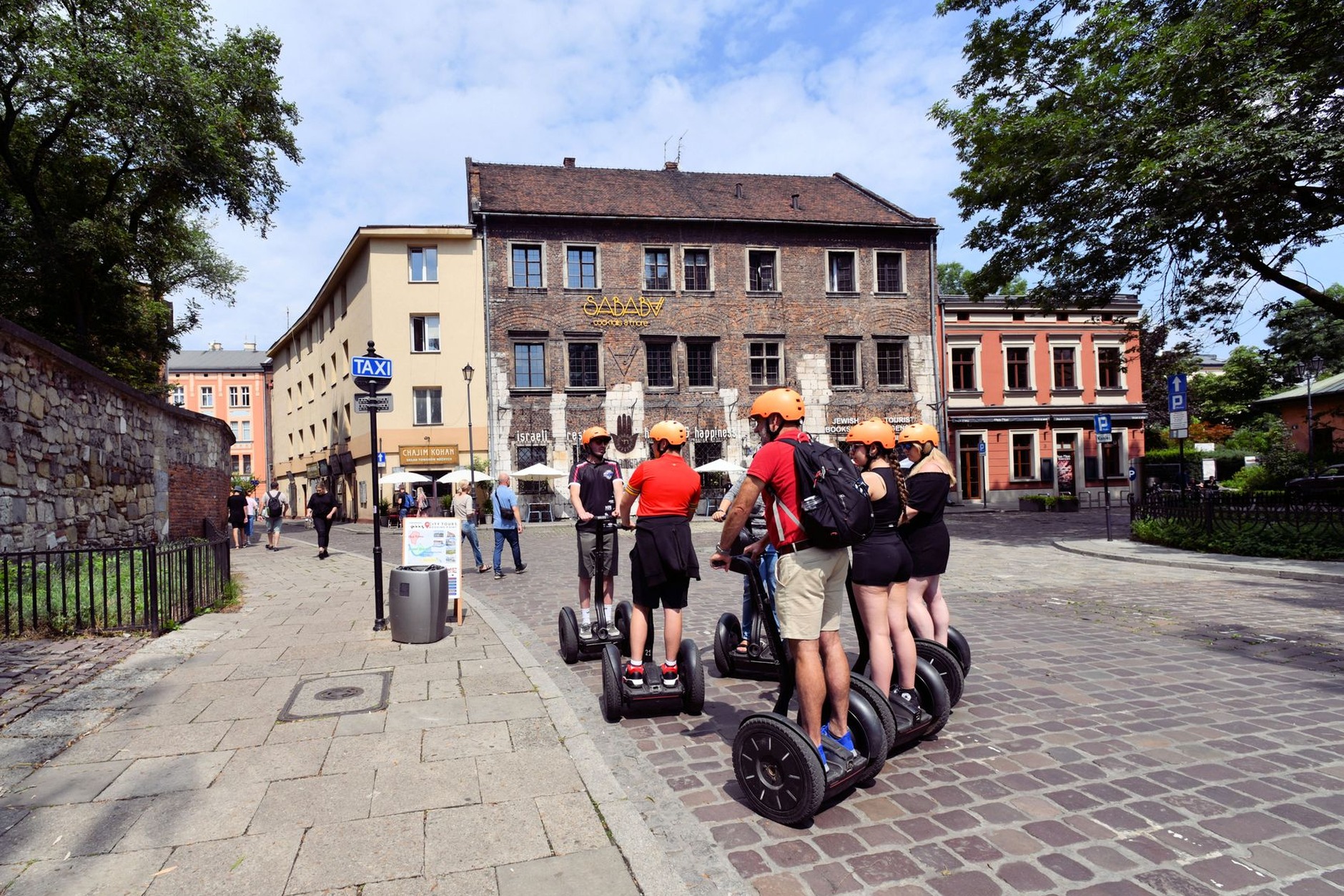 Historic cobblestone street and atmospheric cafe terraces in Krakow's historic Kazimierz Jewish quarter