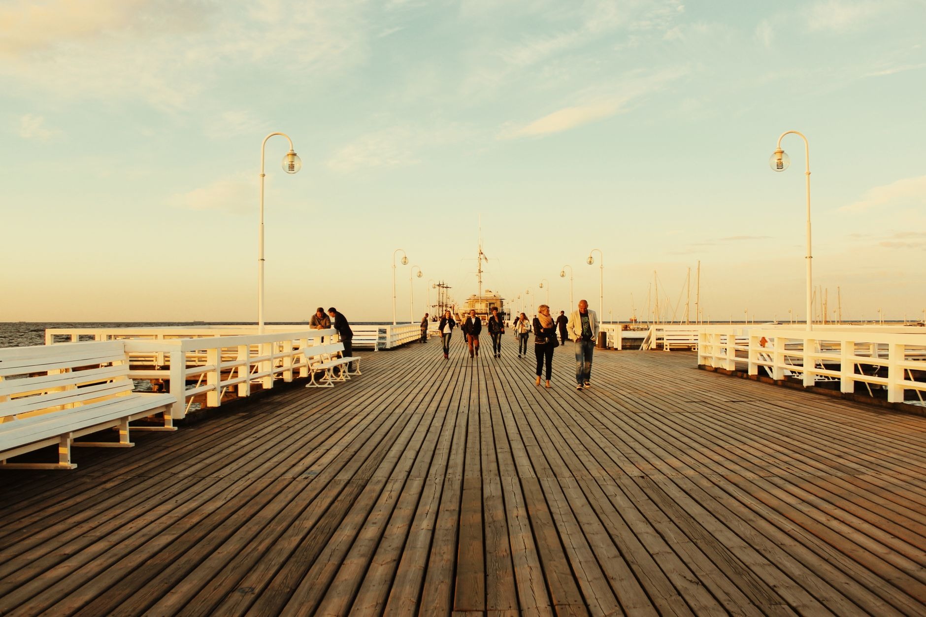 Long historic wooden pier stretching into the calm blue waters of the Baltic Sea in Sopot near Gdansk