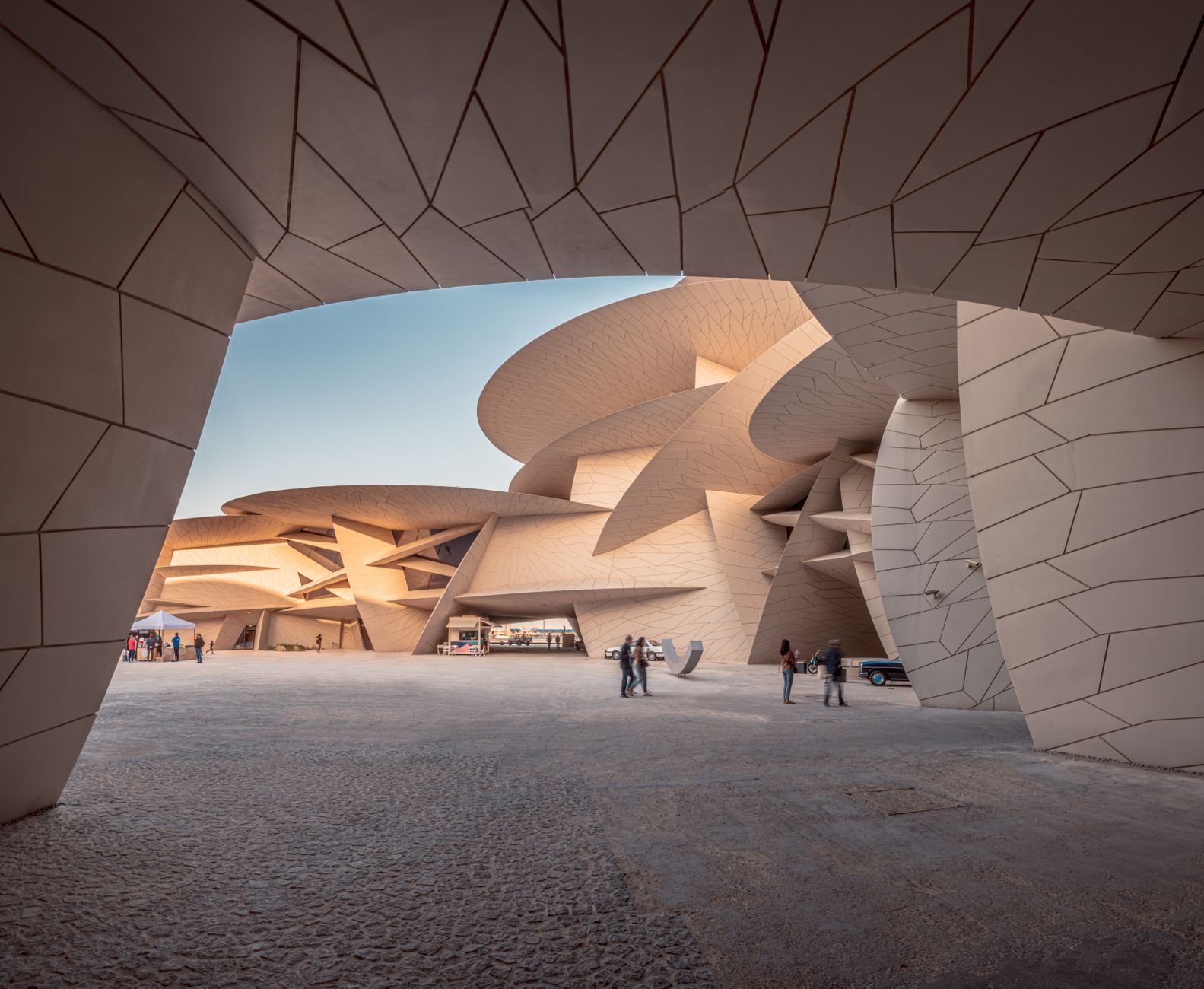 Curving interlocking cantilevered sand-colored discs of the National Museum of Qatar resembling a gigantic crystalline desert rose