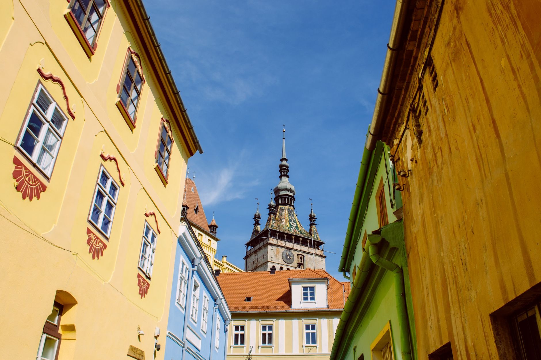 Historic 14th-century stone Clock Tower and colorful medieval houses in the UNESCO-listed citadel of Sighisoara