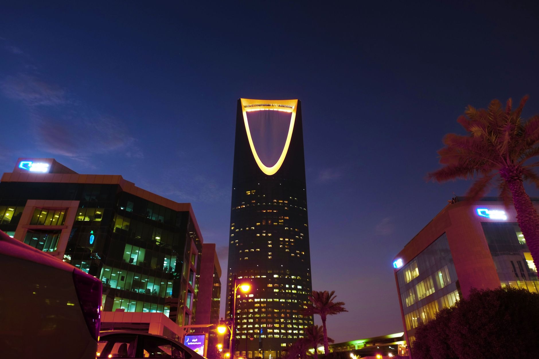 The illuminated curved skyscraper of Kingdom Centre dominating the modern nighttime skyline of Riyadh