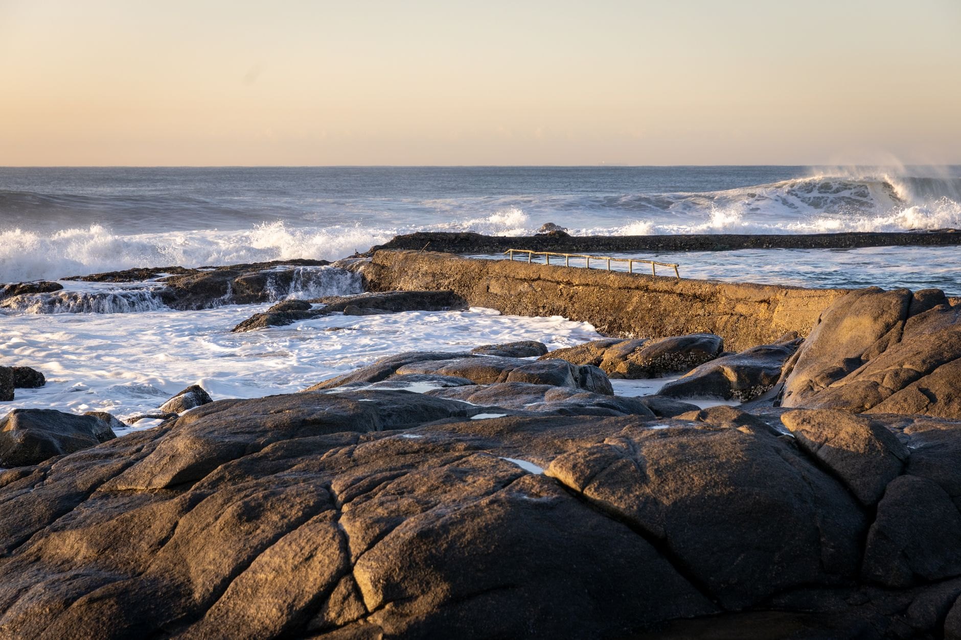 Rugged Atlantic volcanic coastline and breaking ocean waves along Dakar's westernmost continental cliffs