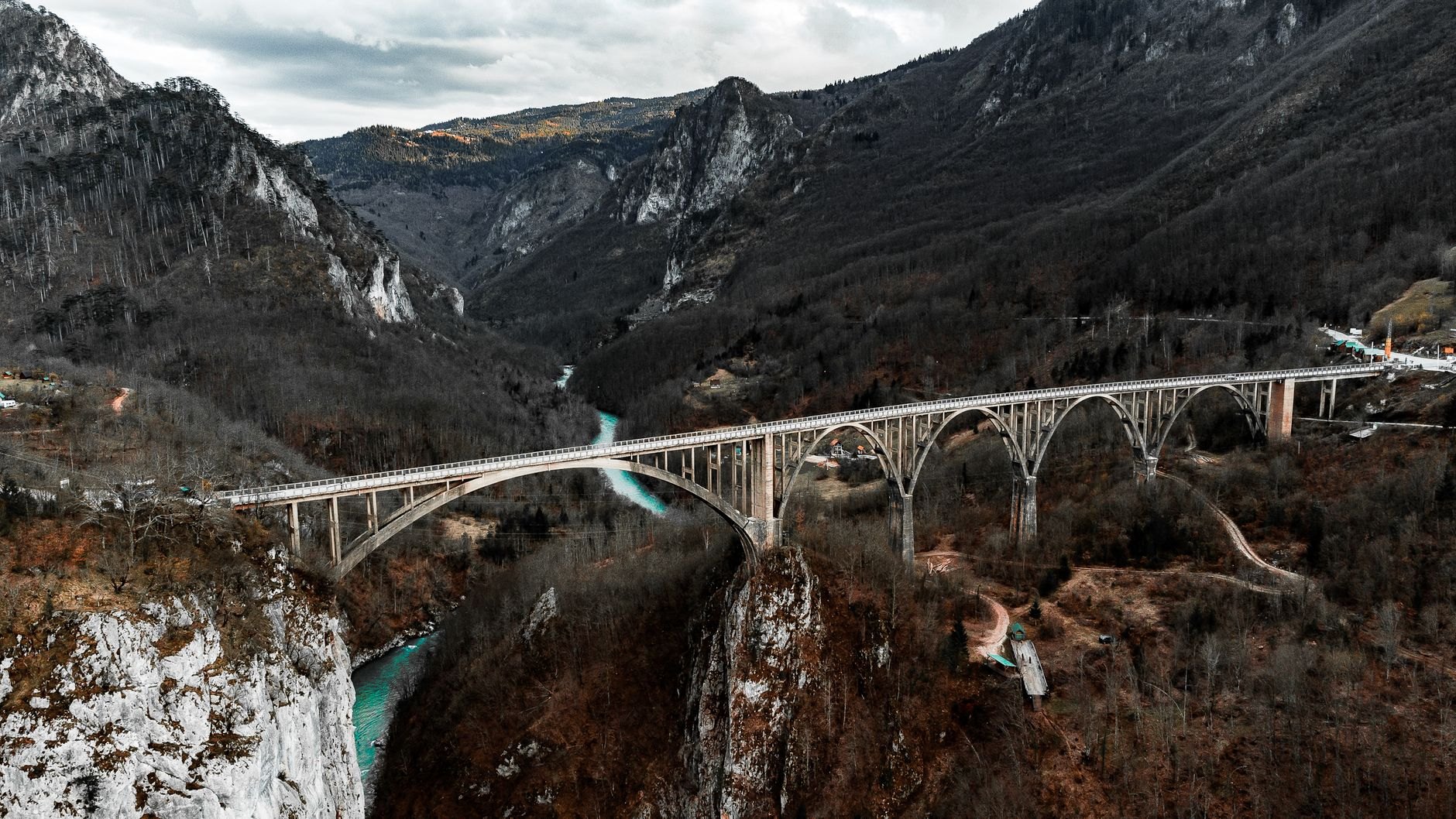 Steep forested limestone cliff at Banjska Stena looking down onto the emerald waters of Perućac Lake and the Drina River canyon