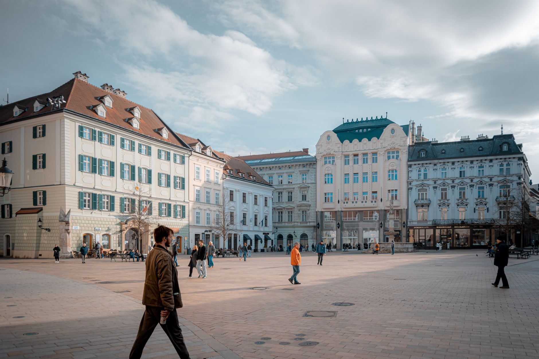 Pastel Baroque and Renaissance facades surrounding the cobblestone Old Town Square and Old Town Hall in Bratislava