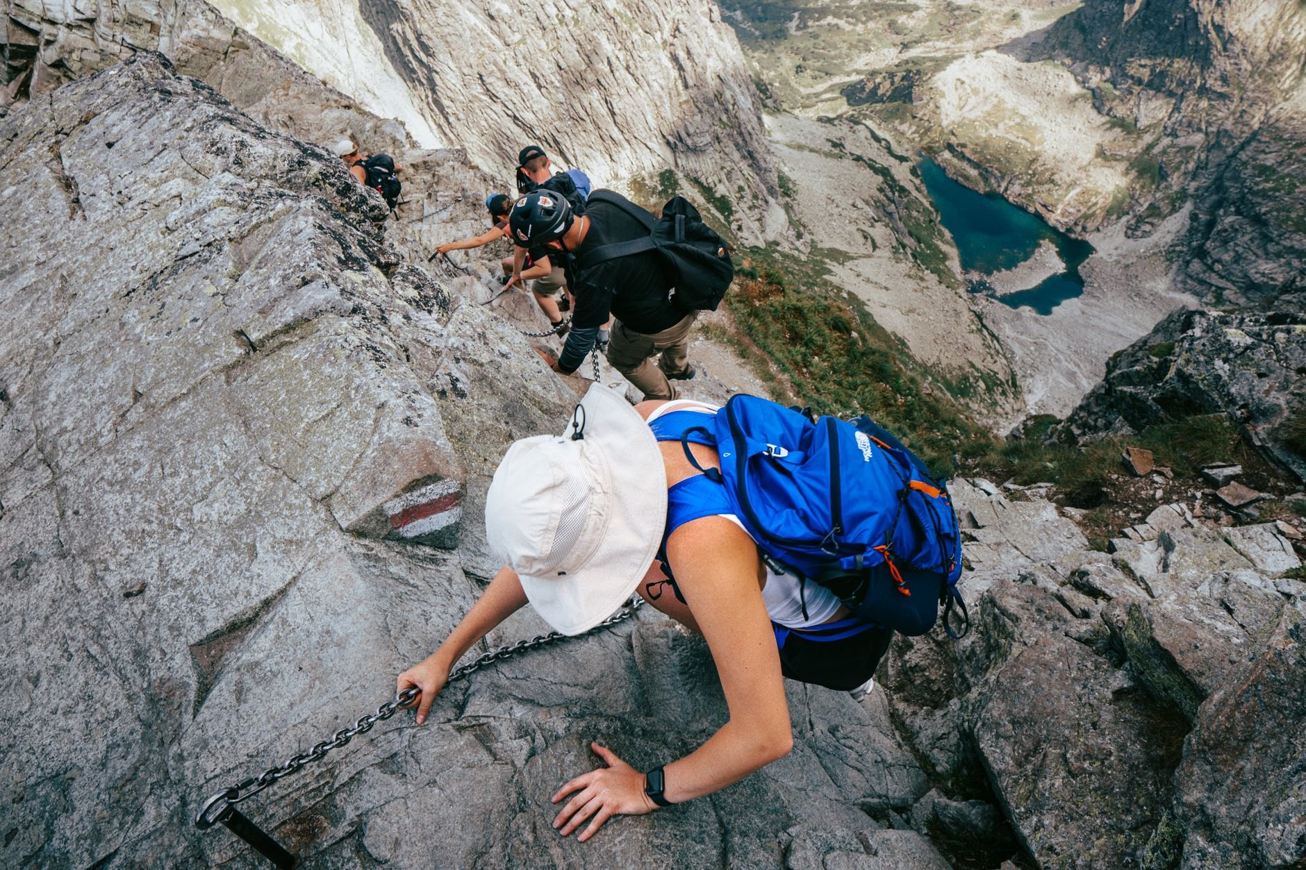 Rocky alpine path winding through dwarf pine and granite scree towards jagged mountain peaks in the High Tatras