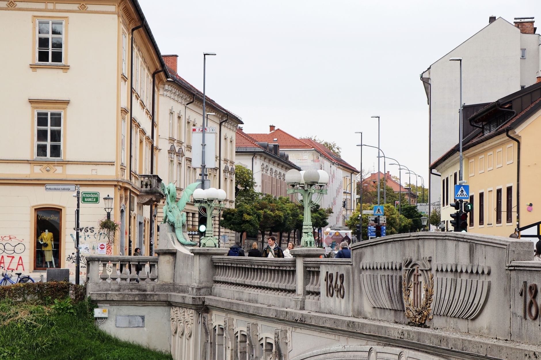 Green copper Art Nouveau dragon sculpture guarding the Dragon Bridge over the emerald Ljubljanica River