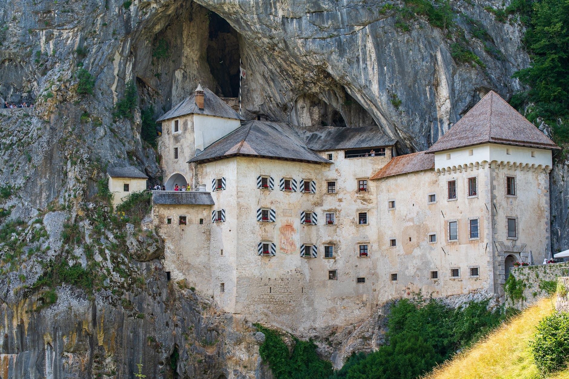 Renaissance stone fortress of Predjama Castle dramatically built into the yawning mouth of a vertical limestone cave