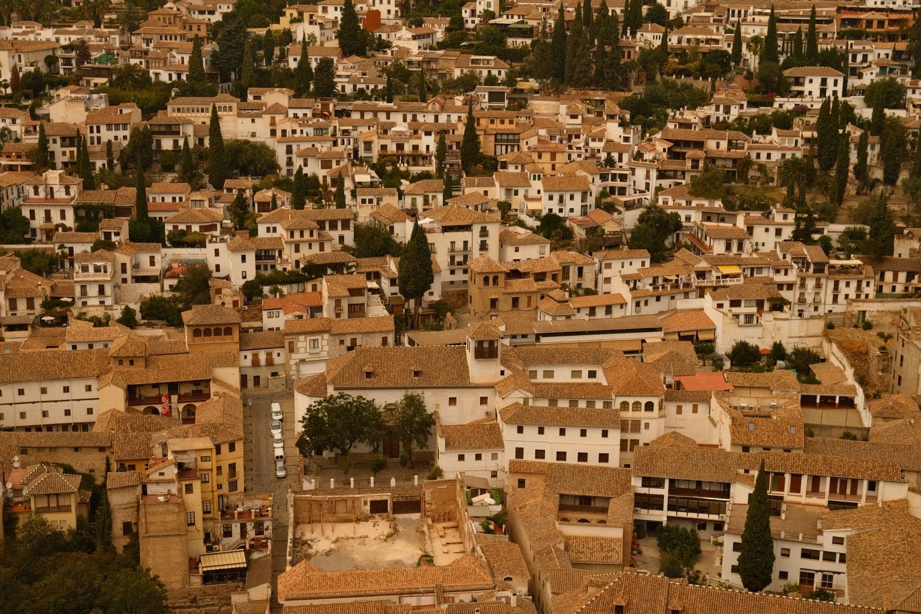 Cobblestone alleyway and whitewashed houses in Granada's historic Albaicín quarter