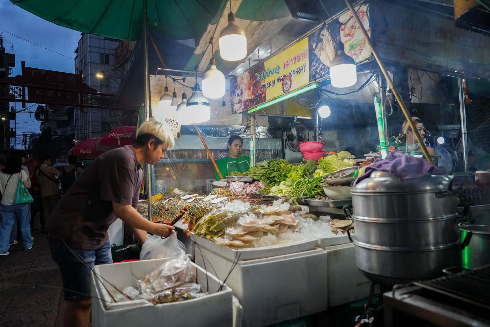 Food stall with seafood and vegetables on Yaowarat Road in Bangkok
