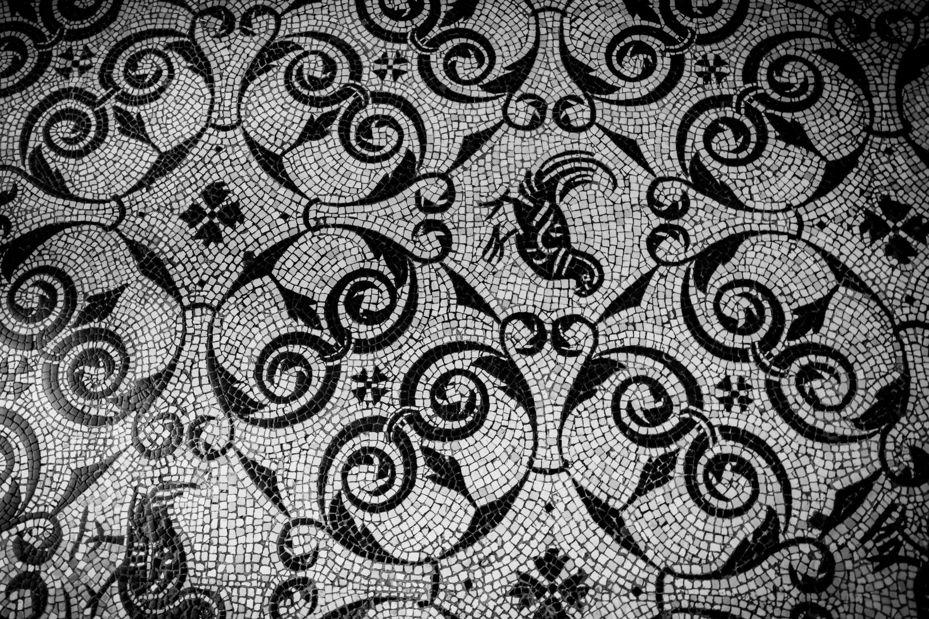 Elaborate classical Roman floor mosaic depicting mythological scenes preserved inside a grand museum hall