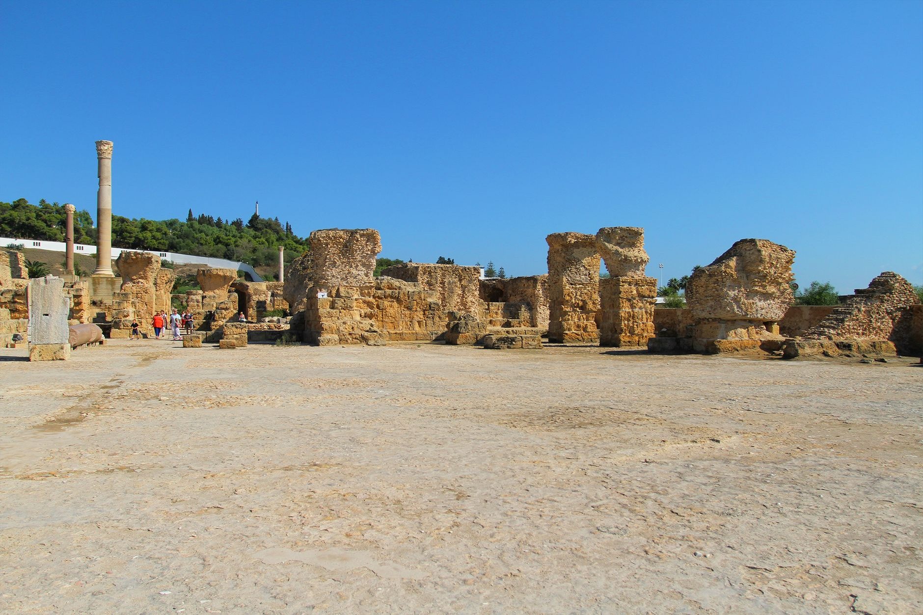 Ancient Roman stone columns and ruined arches of the Antonine Baths in Carthage overlooking the Mediterranean Sea