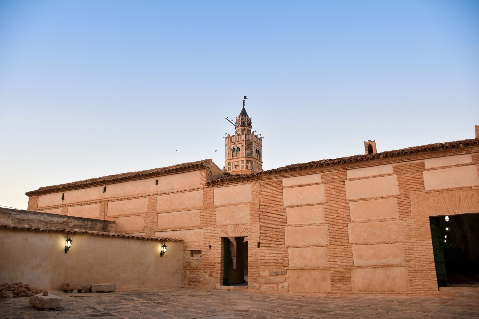 Expansive marble paved courtyard and historic square minaret of the 7th-century Great Mosque of Kairouan