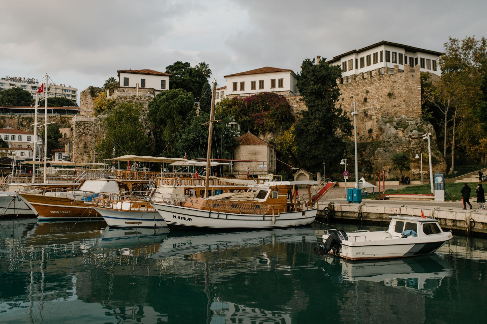 Historic Roman harbor of Kaleiçi sheltered beneath high cliffs and turquoise Mediterranean waters