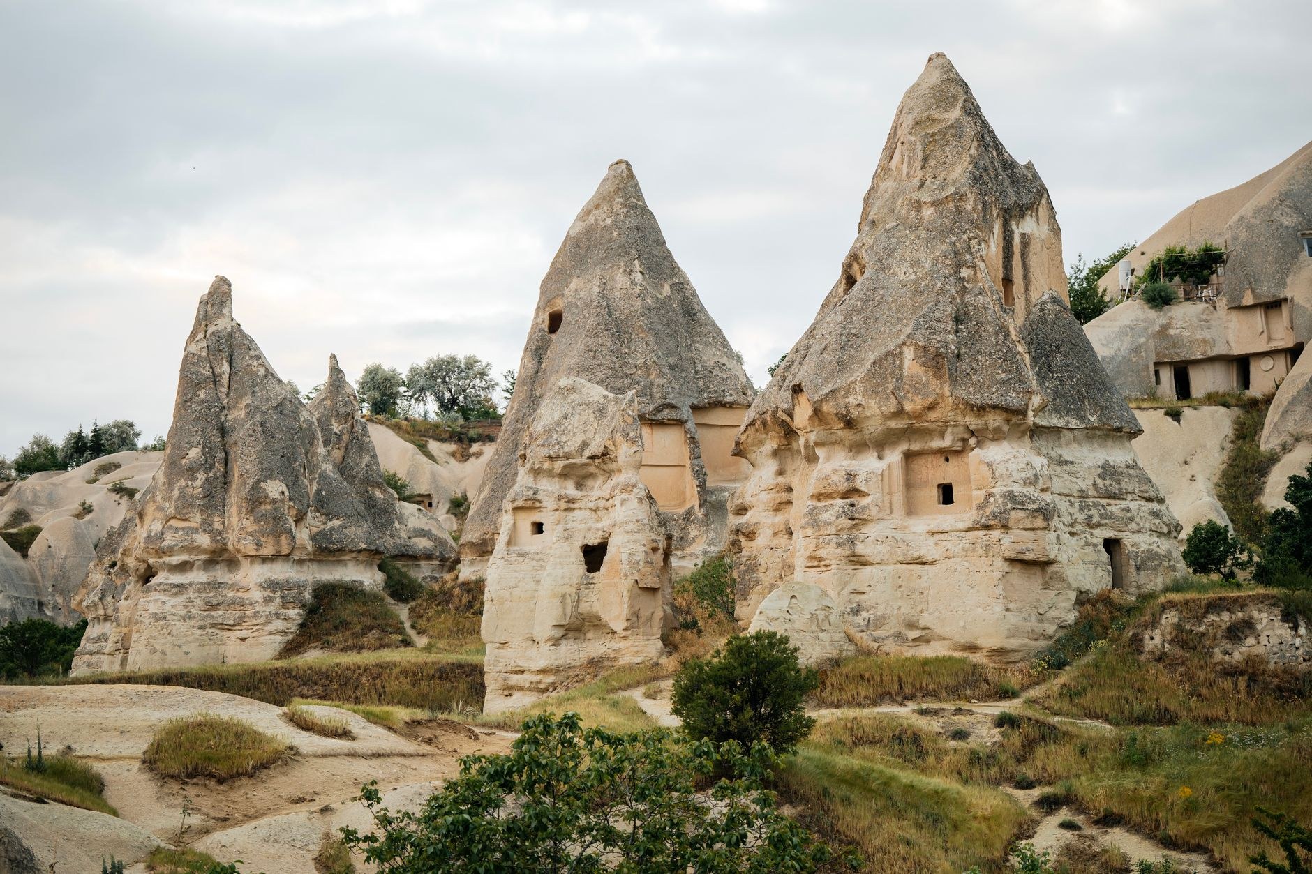 Volcanic tufa rock towers and cave dwellings carved into the hillsides of Cappadocia