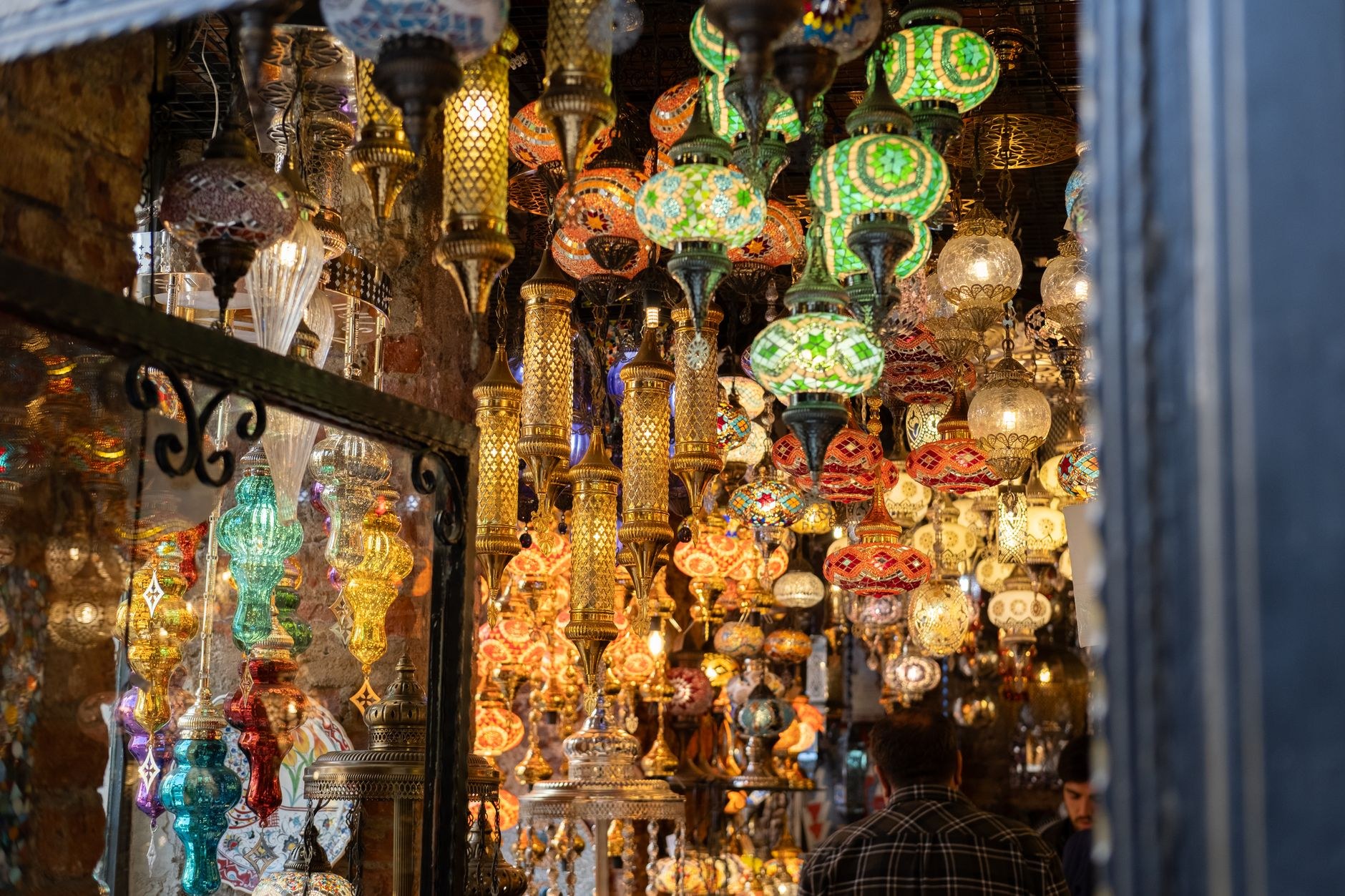 Glowing glass mosaic lamps hanging in the vaulted passageways of the Grand Bazaar