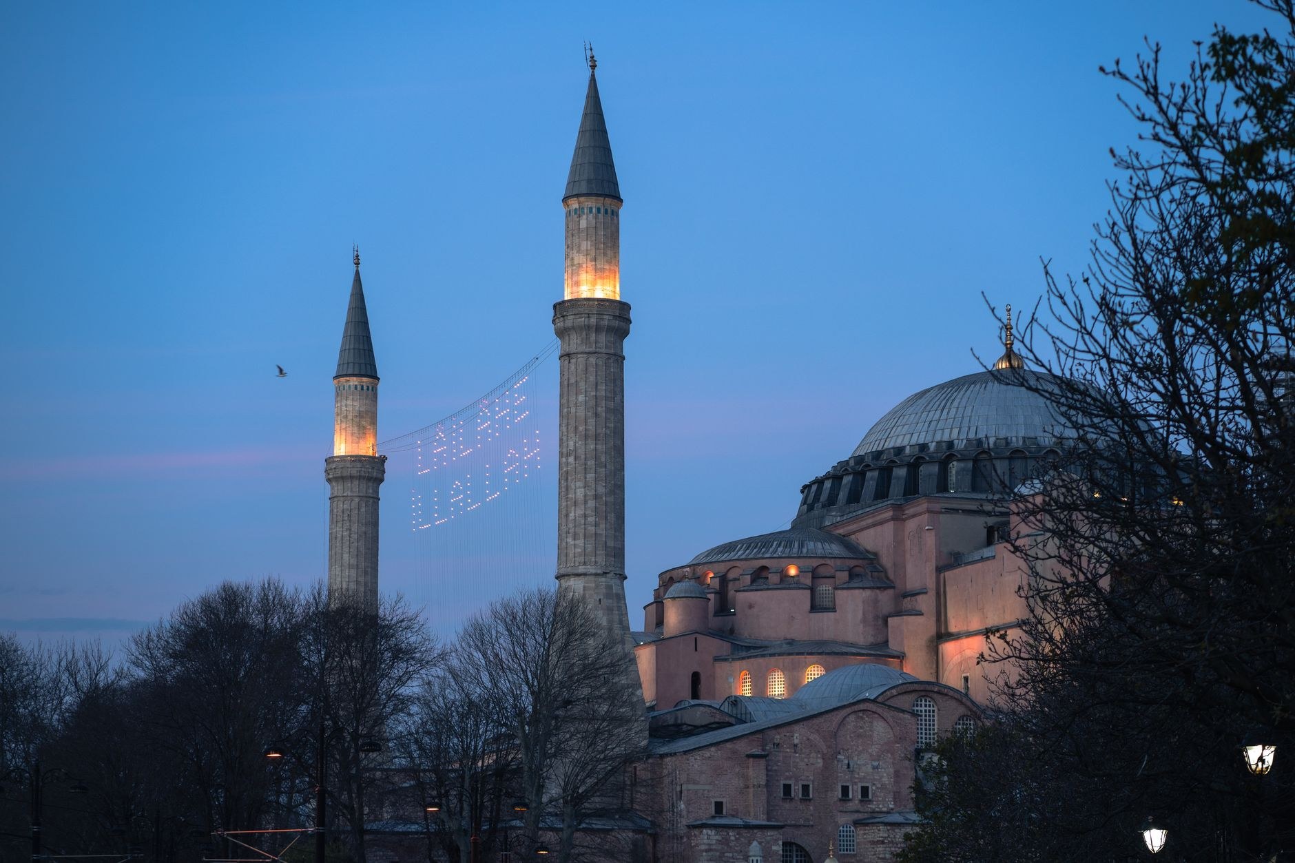 Monumental domes and minarets of Hagia Sophia bathed in golden afternoon sunlight
