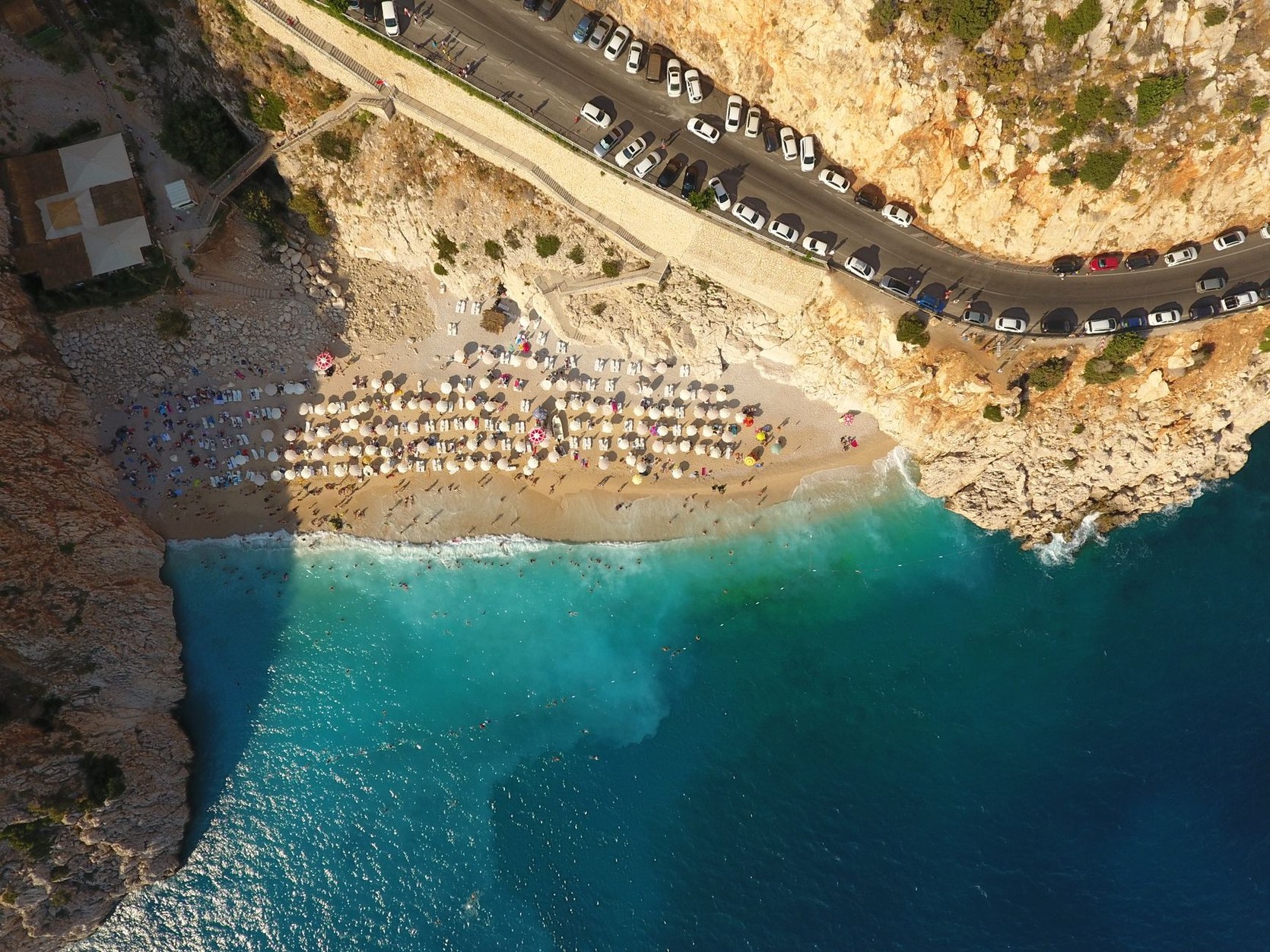 Stunning golden beach and brilliant turquoise water tucked inside a dramatic sea canyon