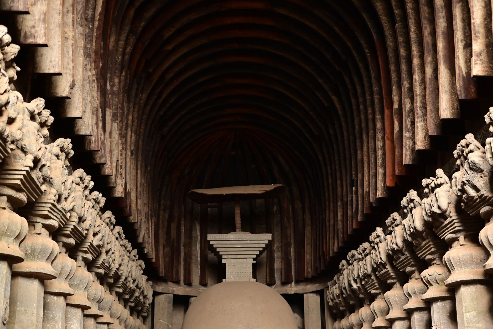 Subterranean stone-carved chambers and narrow corridors in a rock-cut ancient site