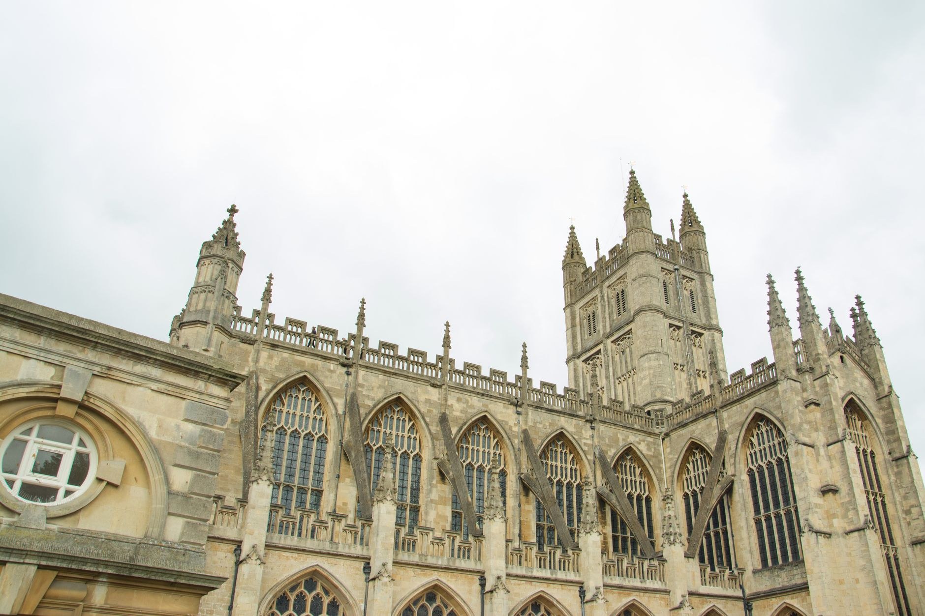 Ancient open-air Roman Baths framed by Bath Abbey and Georgian stone colonnades