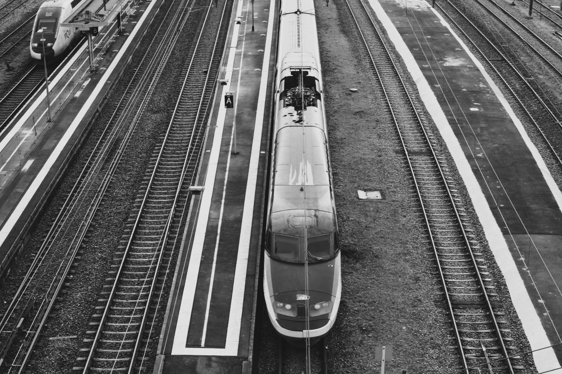 Intercity train waiting at an illuminated platform under arched station glass