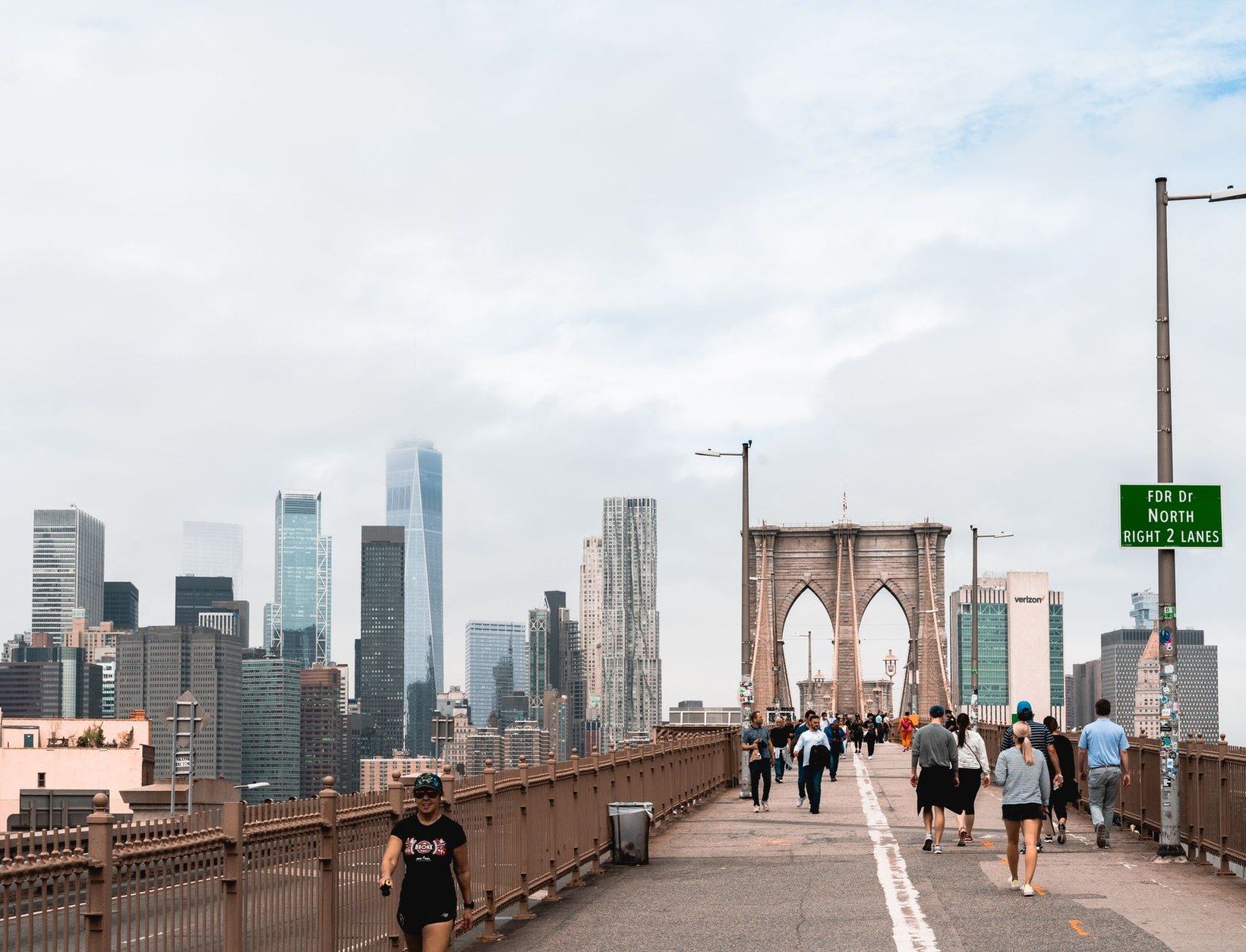 Historic stone arches and timber walkway of the Brooklyn Bridge