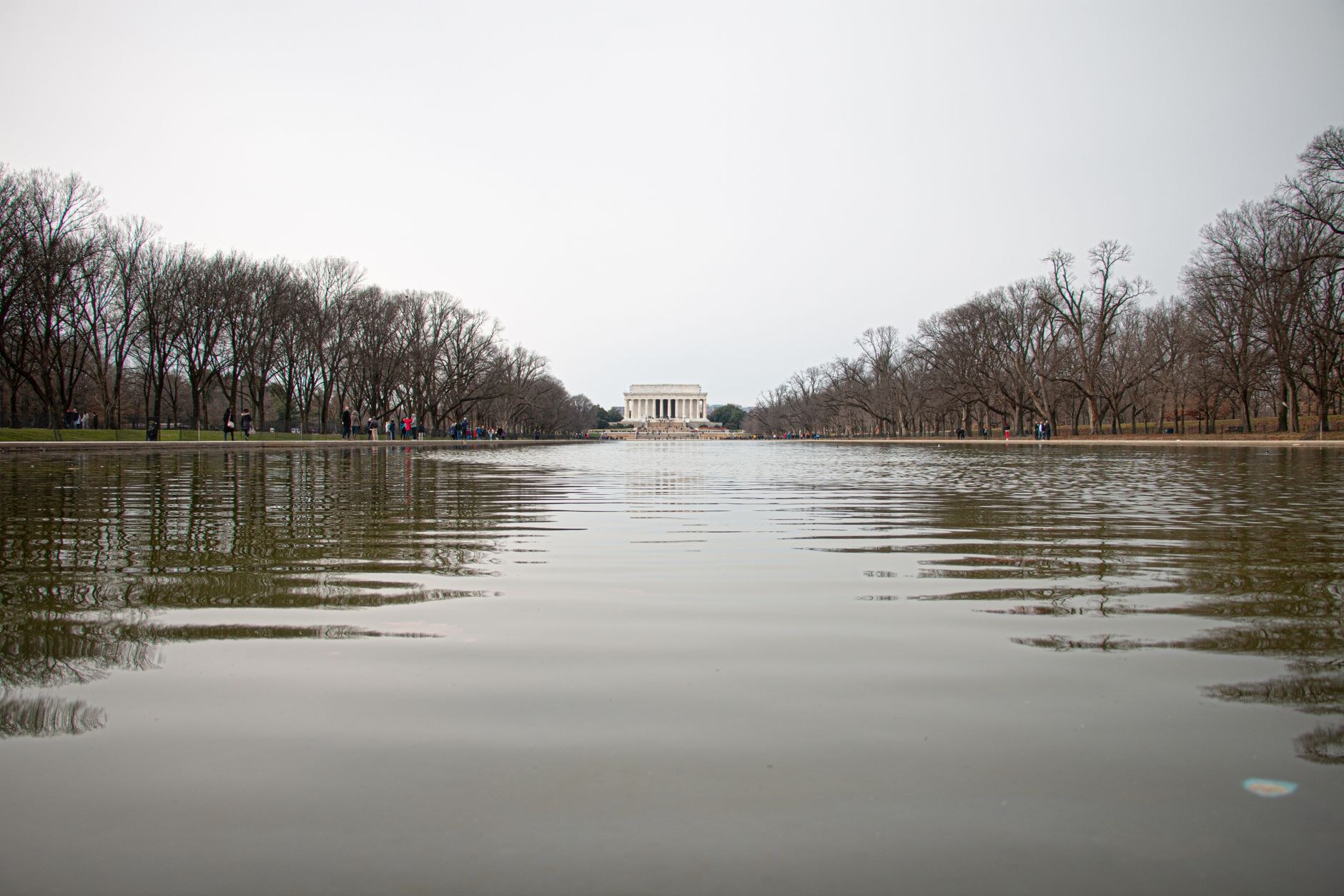 Marble columns of the Lincoln Memorial reflecting on the National Mall pool