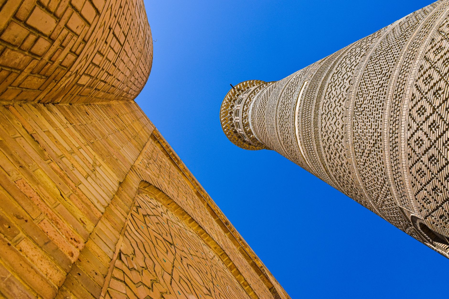 Monumental 12th-century Kalyan Minaret and azure domed Mir-i-Arab Madrasah in the historic center of Bukhara