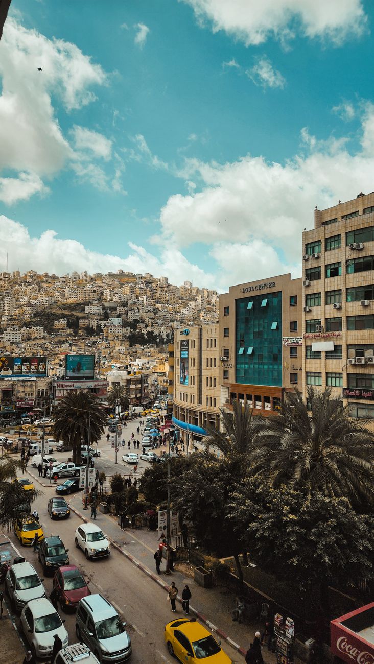 Dense urban limestone architecture and bustling market streets across the northern city of Nablus