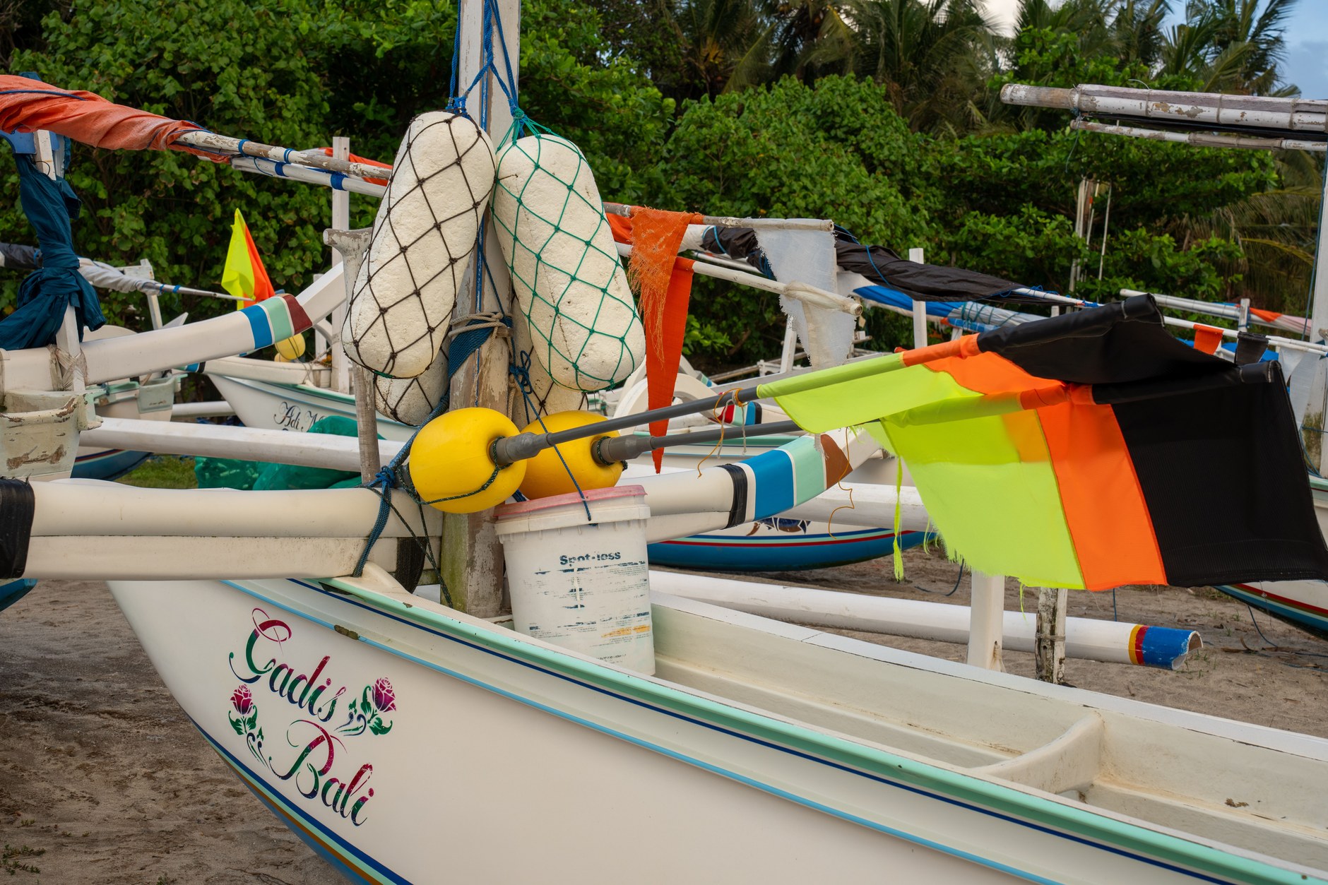 Handcrafted wooden pirogues and traditional fishing craft resting along a coastal beach