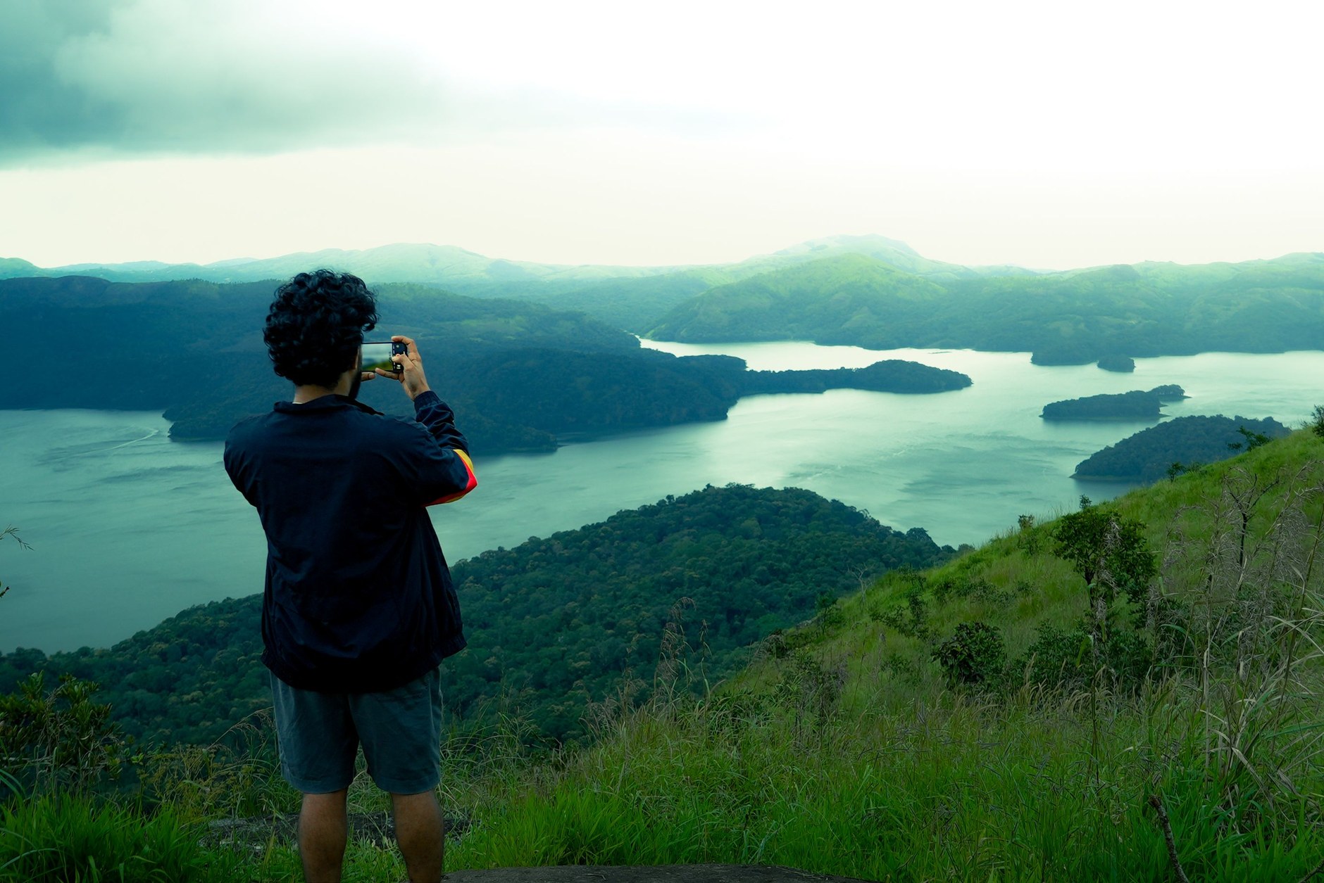 High elevation viewpoint overlooking the vast blue Brokopondo Reservoir and rainforest canopy
