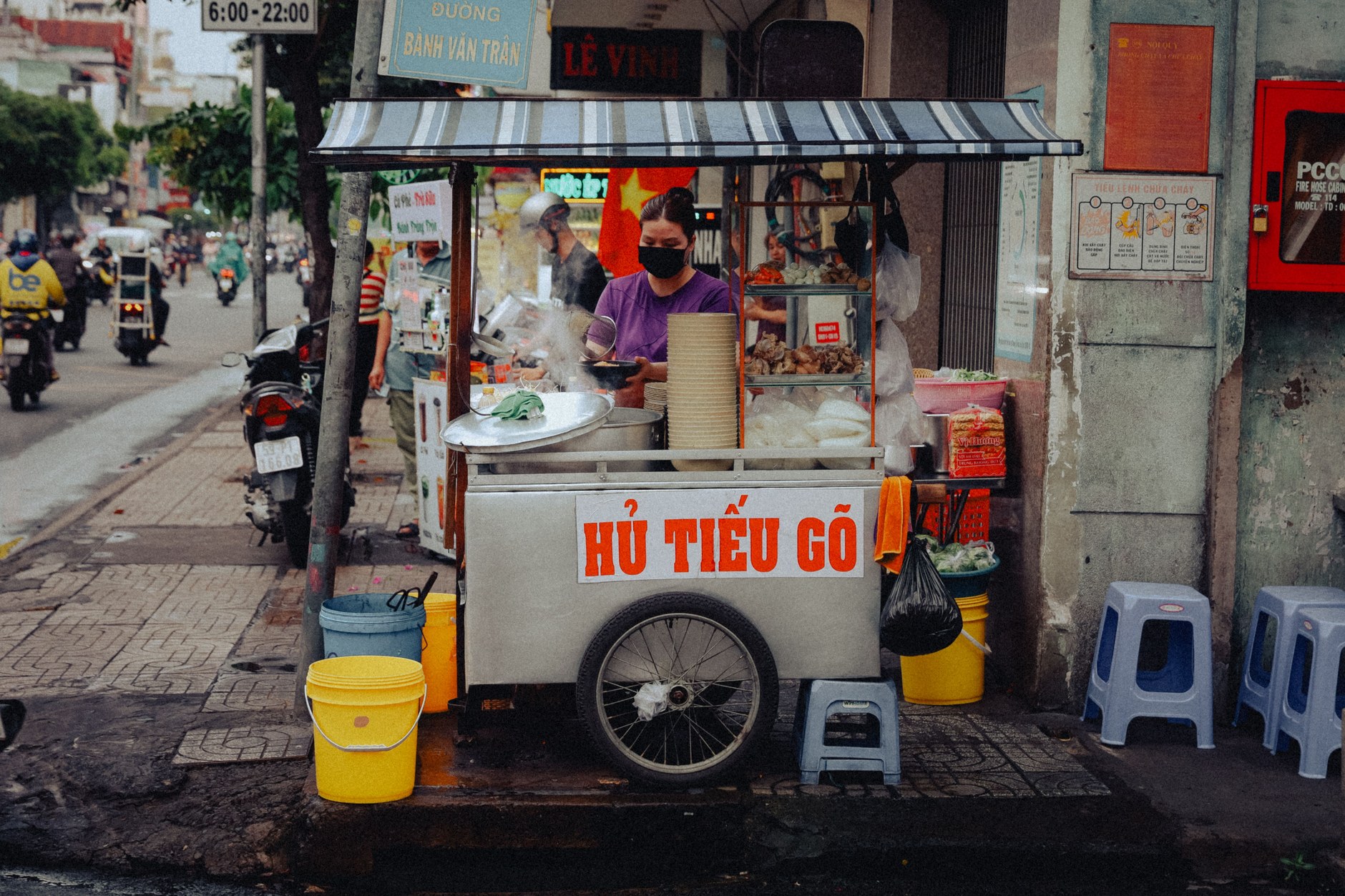 Steaming street food cauldrons and fresh Asian dishes at a night food market in Paramaribo