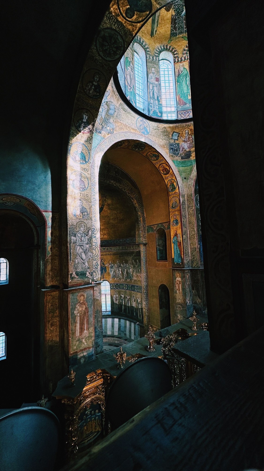 Intricate Byzantine frescoes and stone arches inside Saint Sophia Cathedral in Kyiv, Ukraine