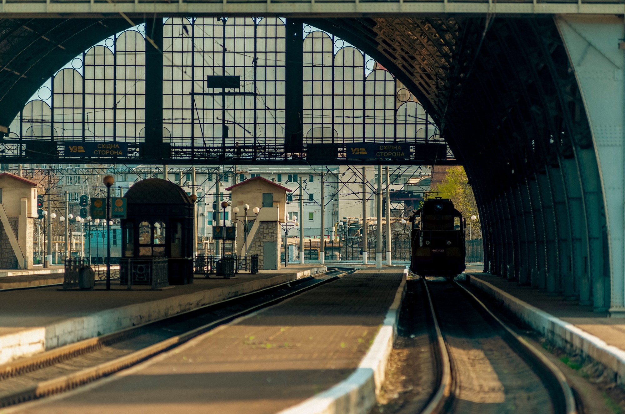 Interior view of the historic arched glass roof and railway platforms of Lviv Central Railway Station