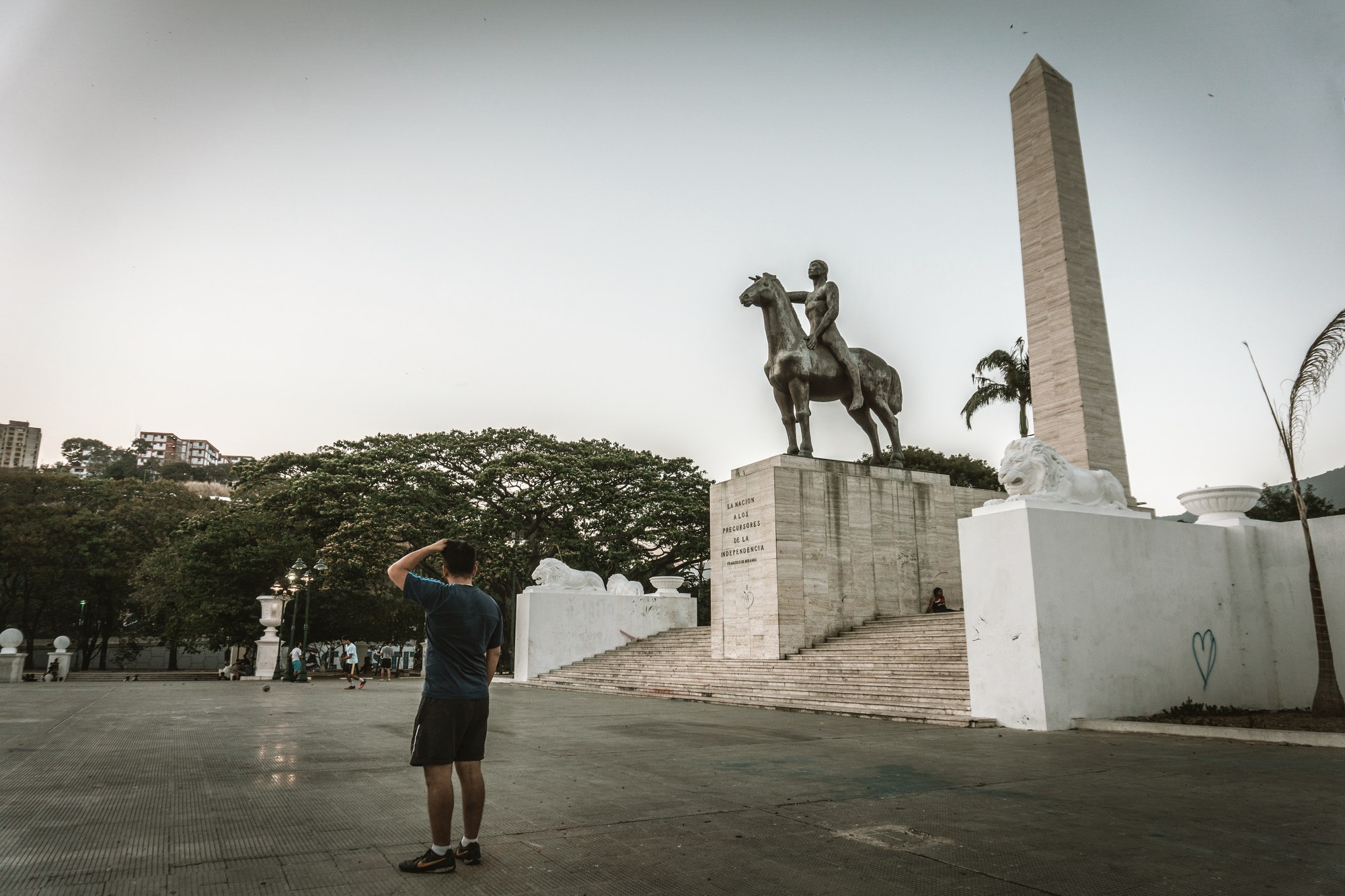 Historic statue of Simón Bolívar in Plaza Bolívar surrounded by palm trees in downtown Caracas