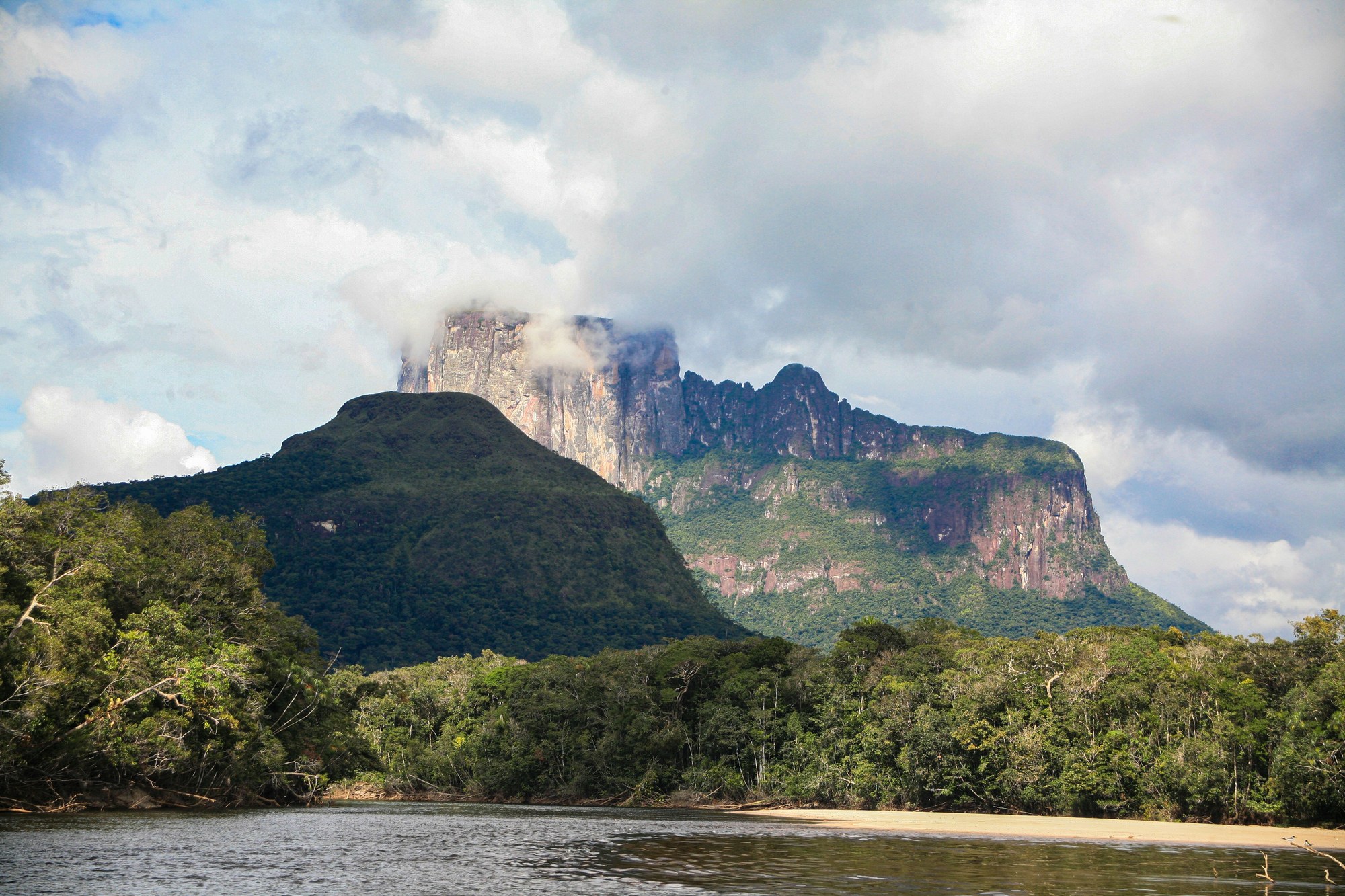 Majestic sandstone tepui mesa surrounded by dense green rainforest canopy in southern Venezuela