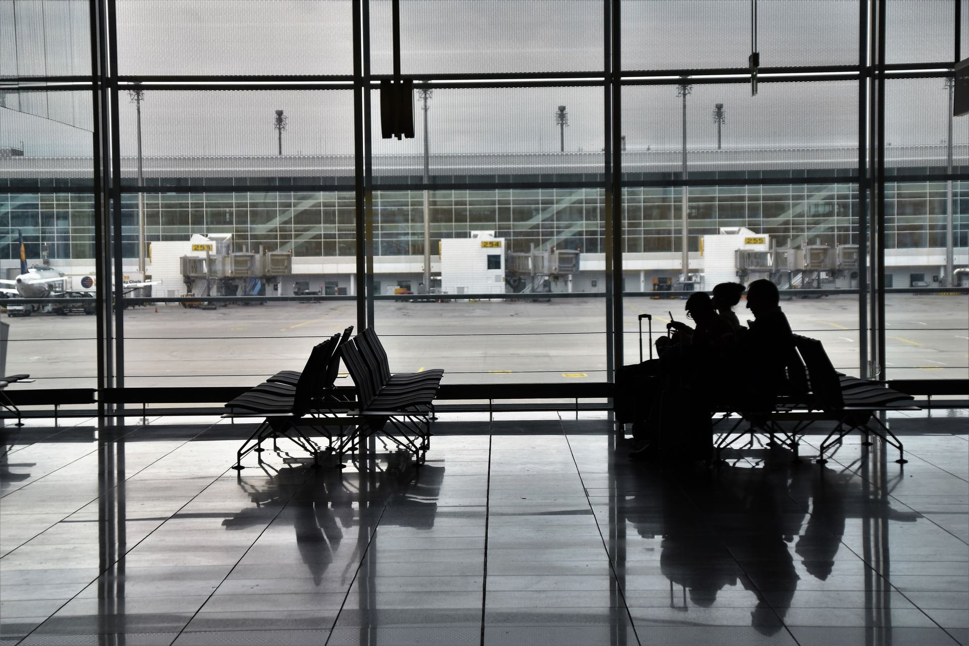 Silhouettes of aircraft on the airport tarmac at evening twilight