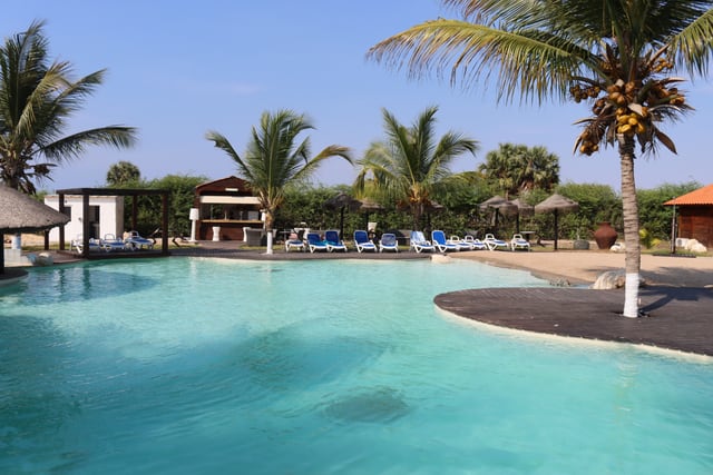 Relaxing poolside view at a luxury tropical resort in Caboledo, Angola.