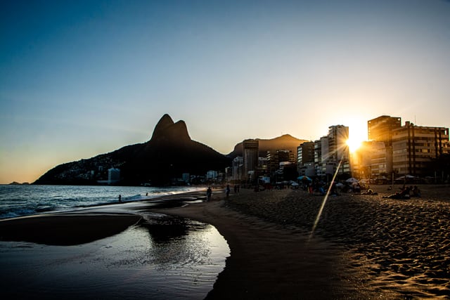 Stunning sunset view at Ipanema Beach, Rio de Janeiro with Dois Irmãos Mountain in the background.