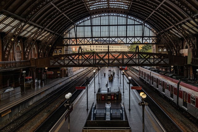 High-angle view of São Paulo train station with iconic arched roof and railway tracks.