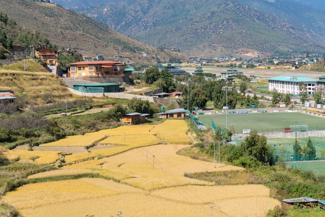 Beautiful aerial view of Paro Valley with rice fields and mountains in Bhutan.