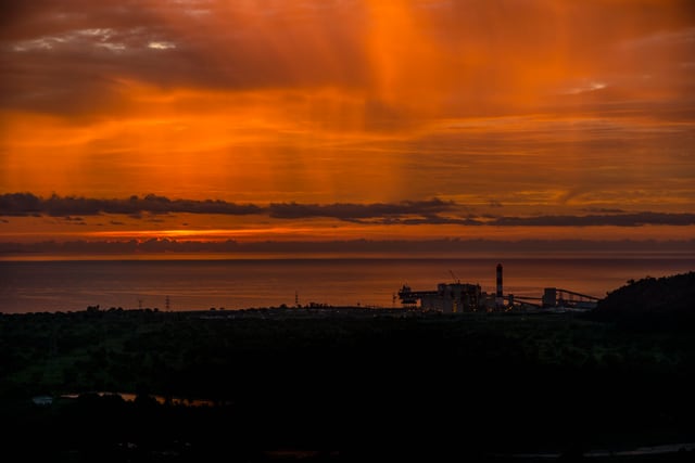 Stunning sunset with orange hues over Malita's coastline, capturing a breathtaking view.