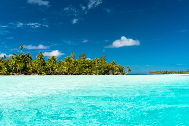 Stunning tropical island Huahine with turquoise water and coconut trees in French Polynesia.